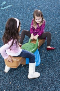 Little girls playing on seesaw