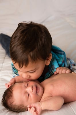 Little-Boy-Giving-Kiss-to-Newborn-Baby-Brother-000084377879_Large.jpg