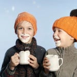 Two boys laughing with whipped cream on their faces