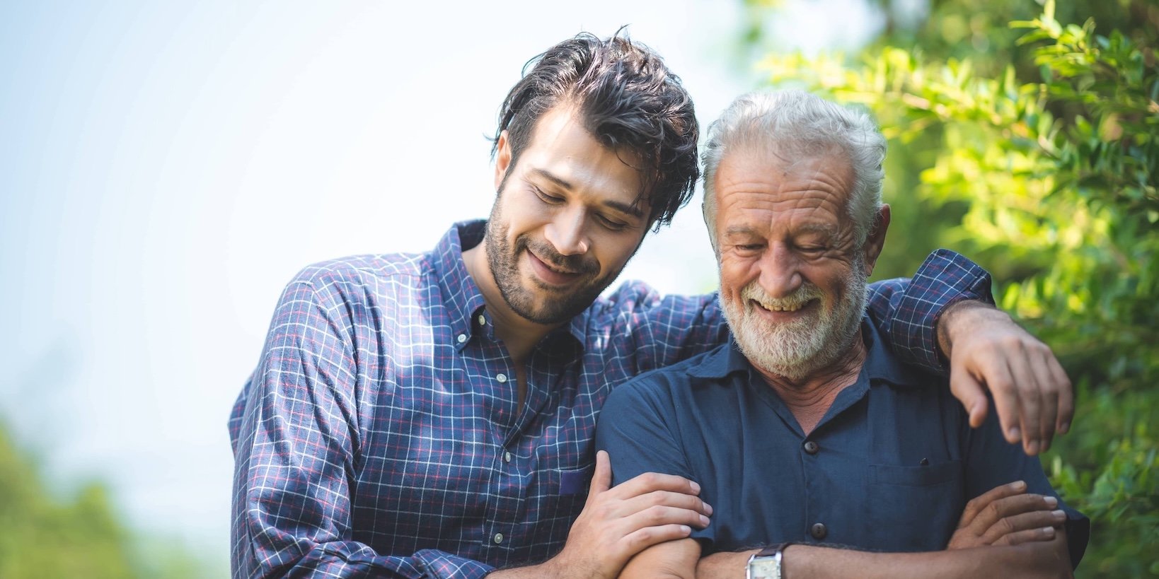 A father and adult son in a moment of closeness and connection.