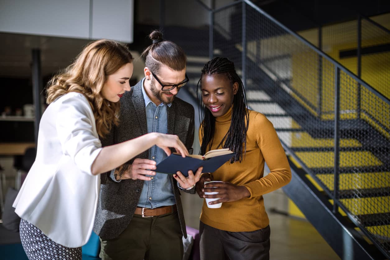 A group of business people in the office building lobby in a diverse company culture.