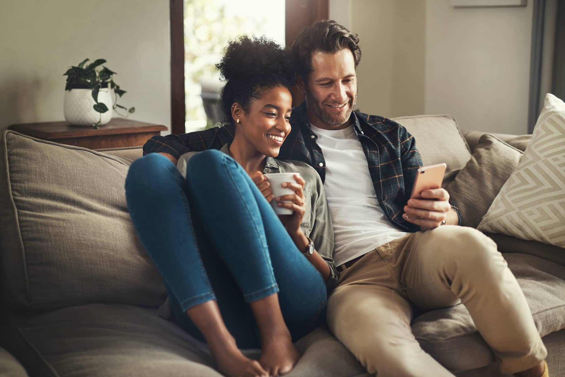 A happy young couple using a digital tablet.