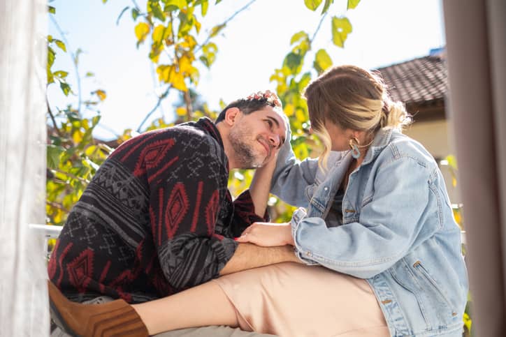 A married couple with conflicting parenting styles discussing how to unify their parenting approach.