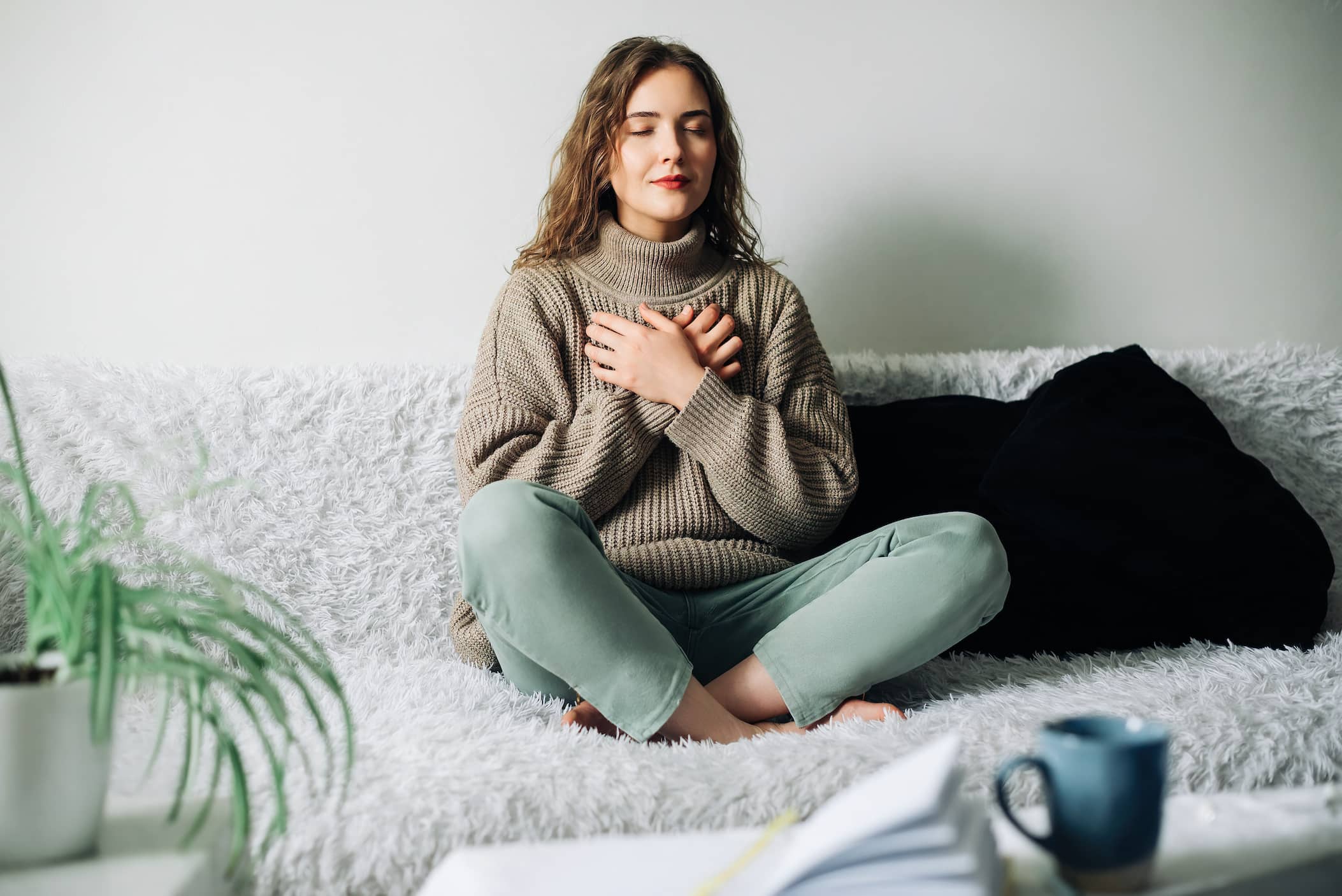 A young woman practicing mindfulness in lotus position.