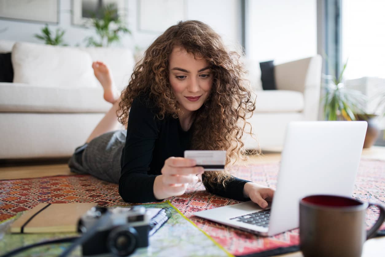 A young woman on a computer doing online shopping.