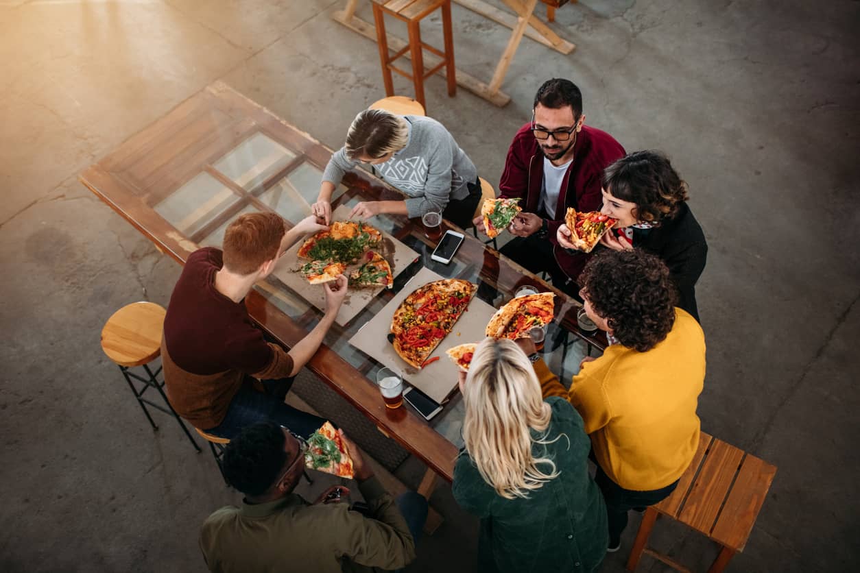 Friends having pizza at a restaurant