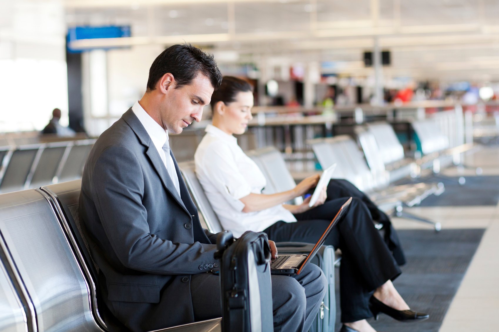 Airport terminal and people plugged into technology