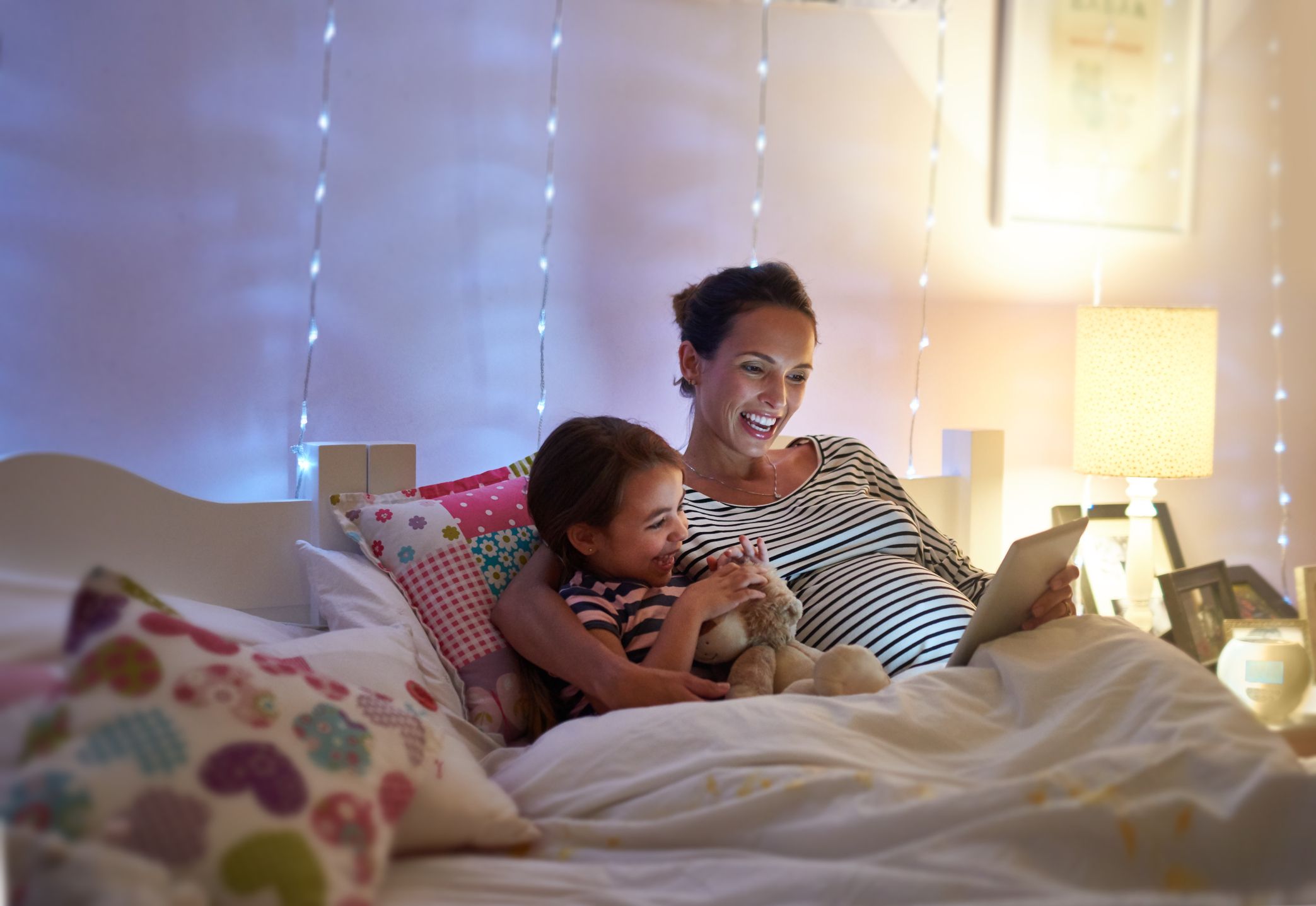 Pregnant mom reading to her daughter