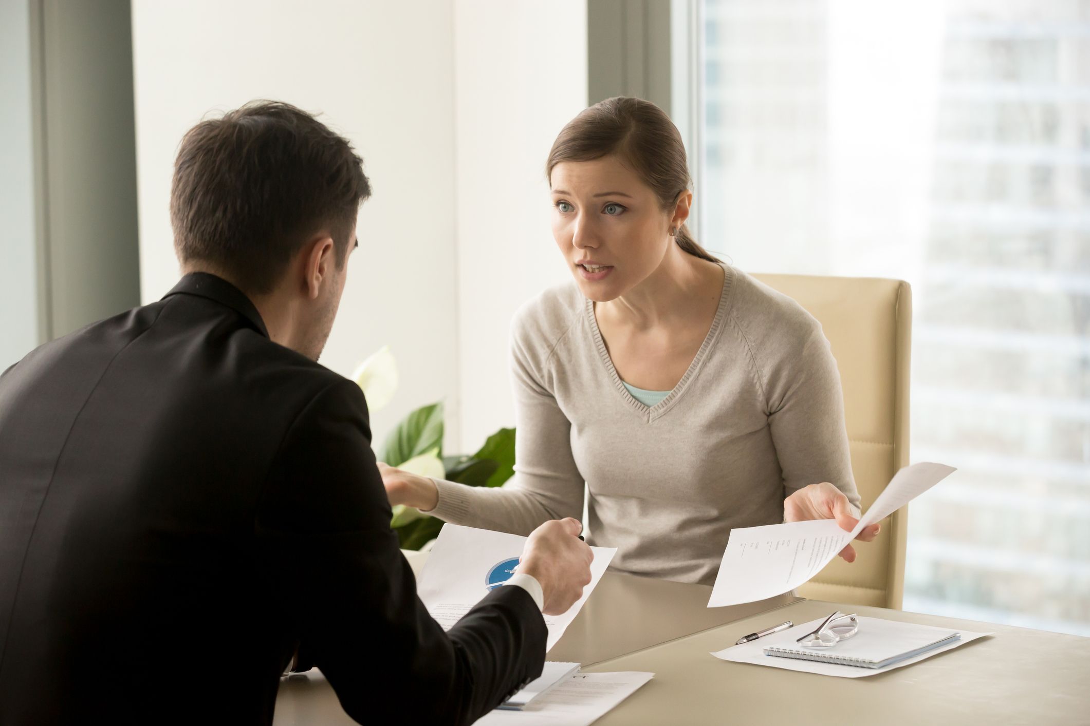 Angry business woman confronting her boss