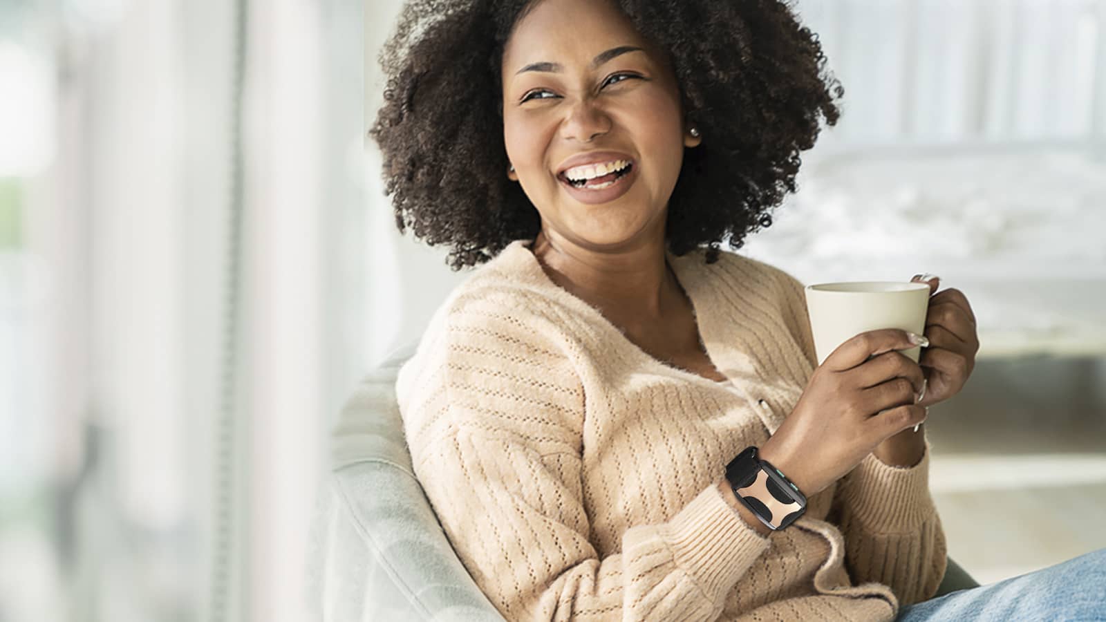 Woman having coffee while wearing an Apollo wearable.