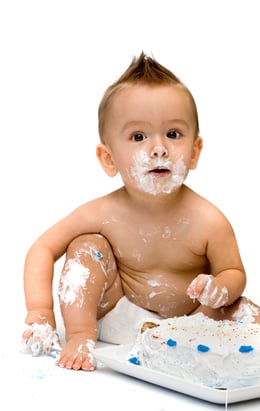 Toddler mistaking a cake for a booster chair