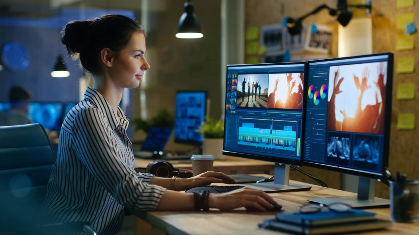 Woman editing music on her computer in Creative Suite