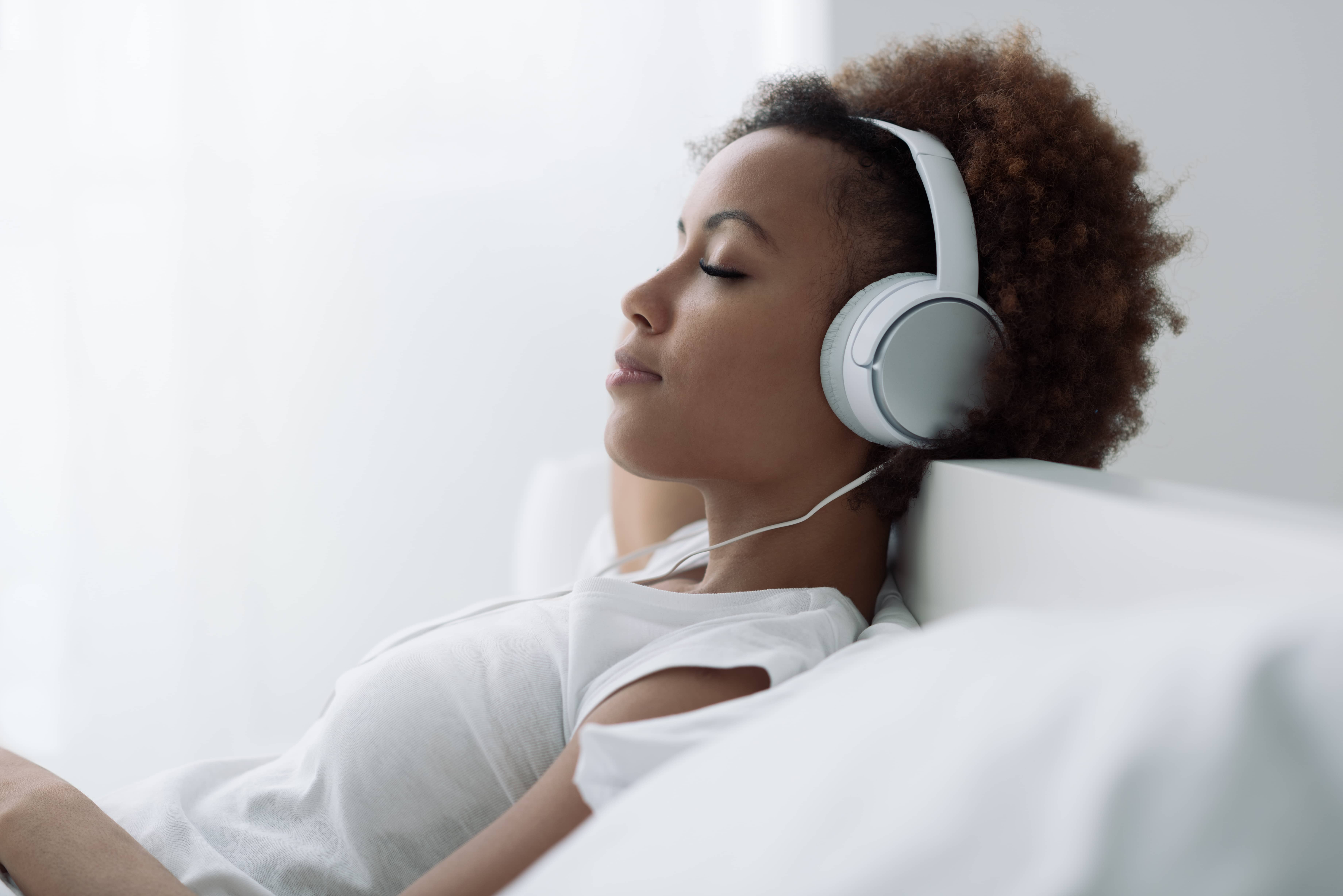 Black woman listening to music to relieve stress
