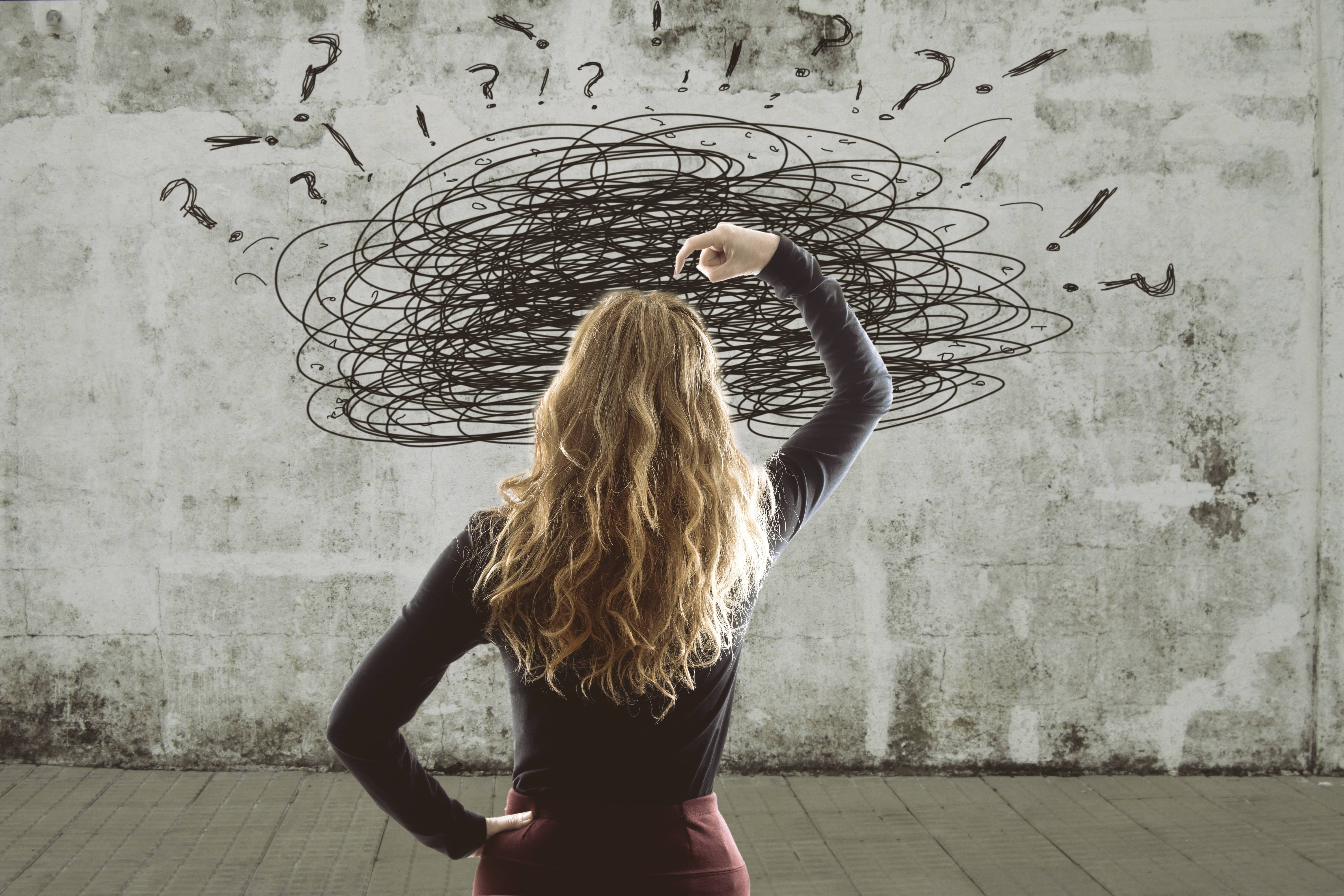 A blonde woman with scribbles overhead symbolizing emotional turbulence.