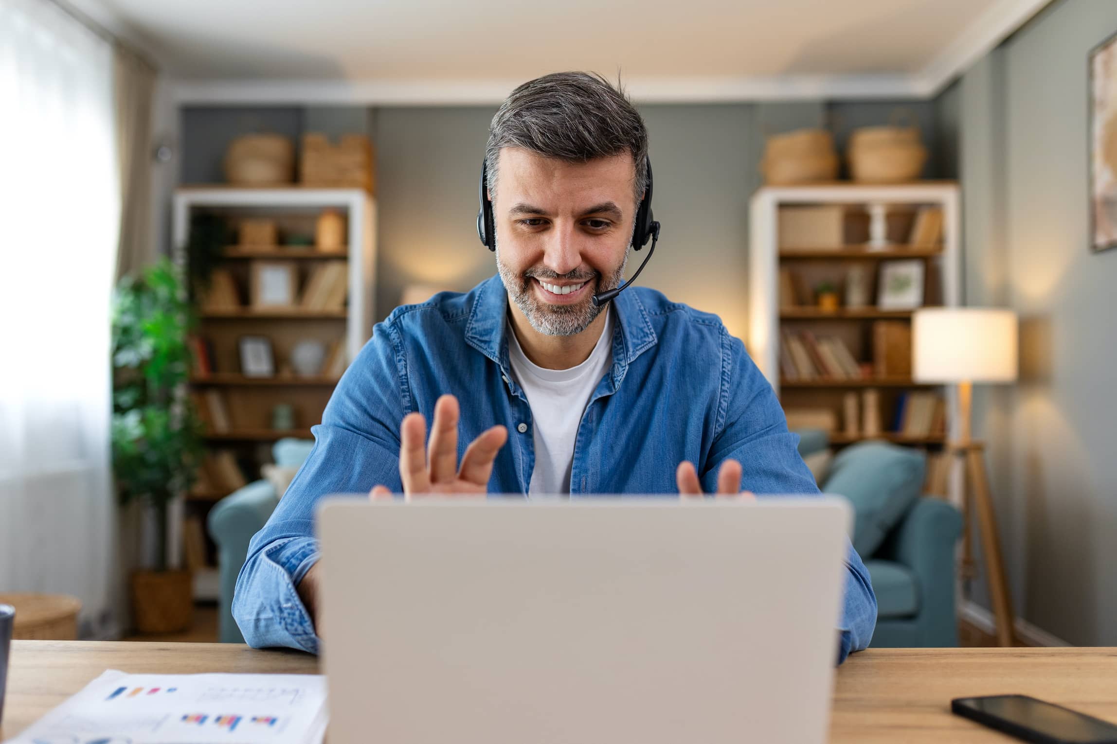 Business man with headsets working on laptop at home office