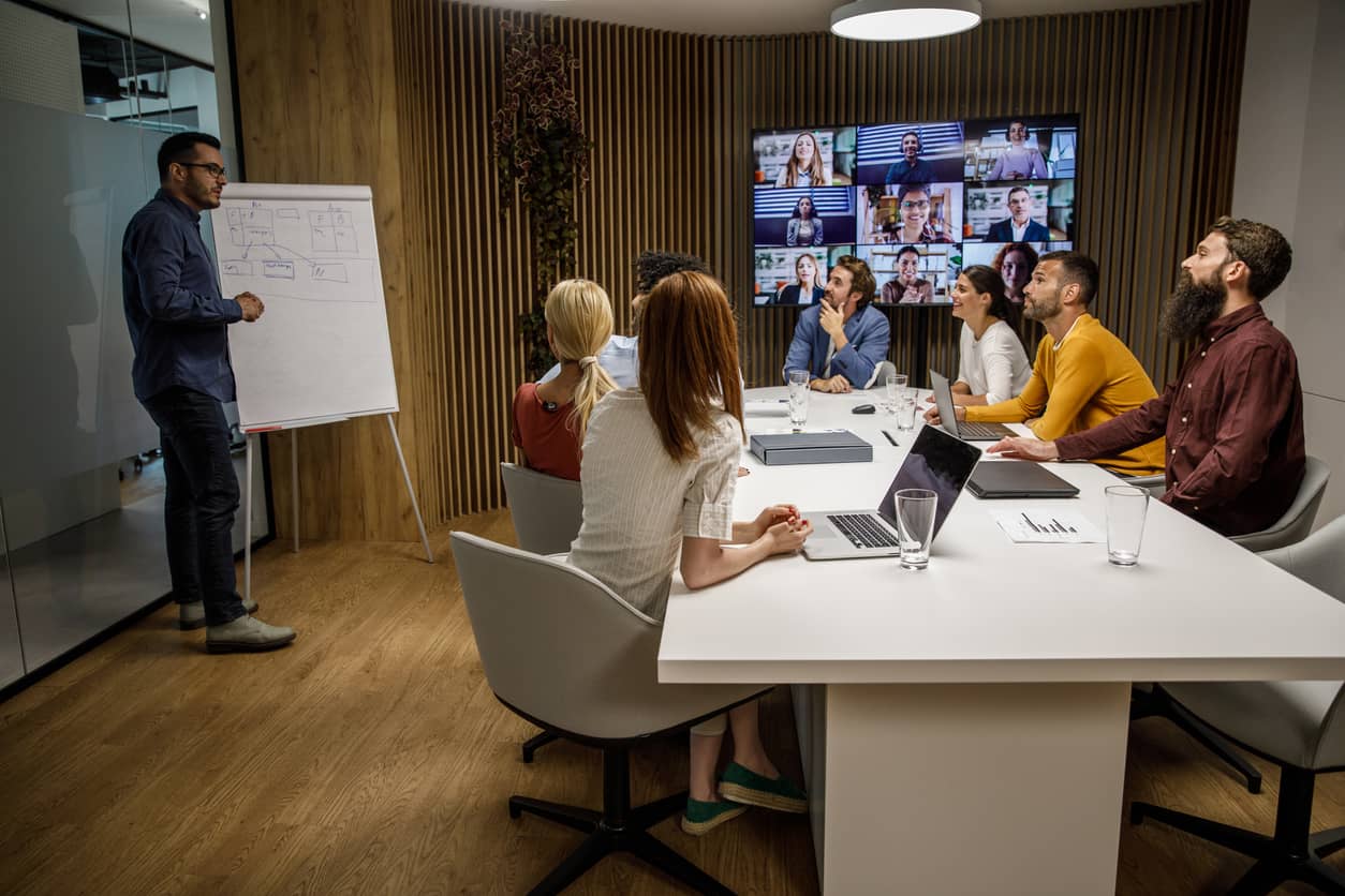 Leader holding a presentation with both in-person and virtual employees.