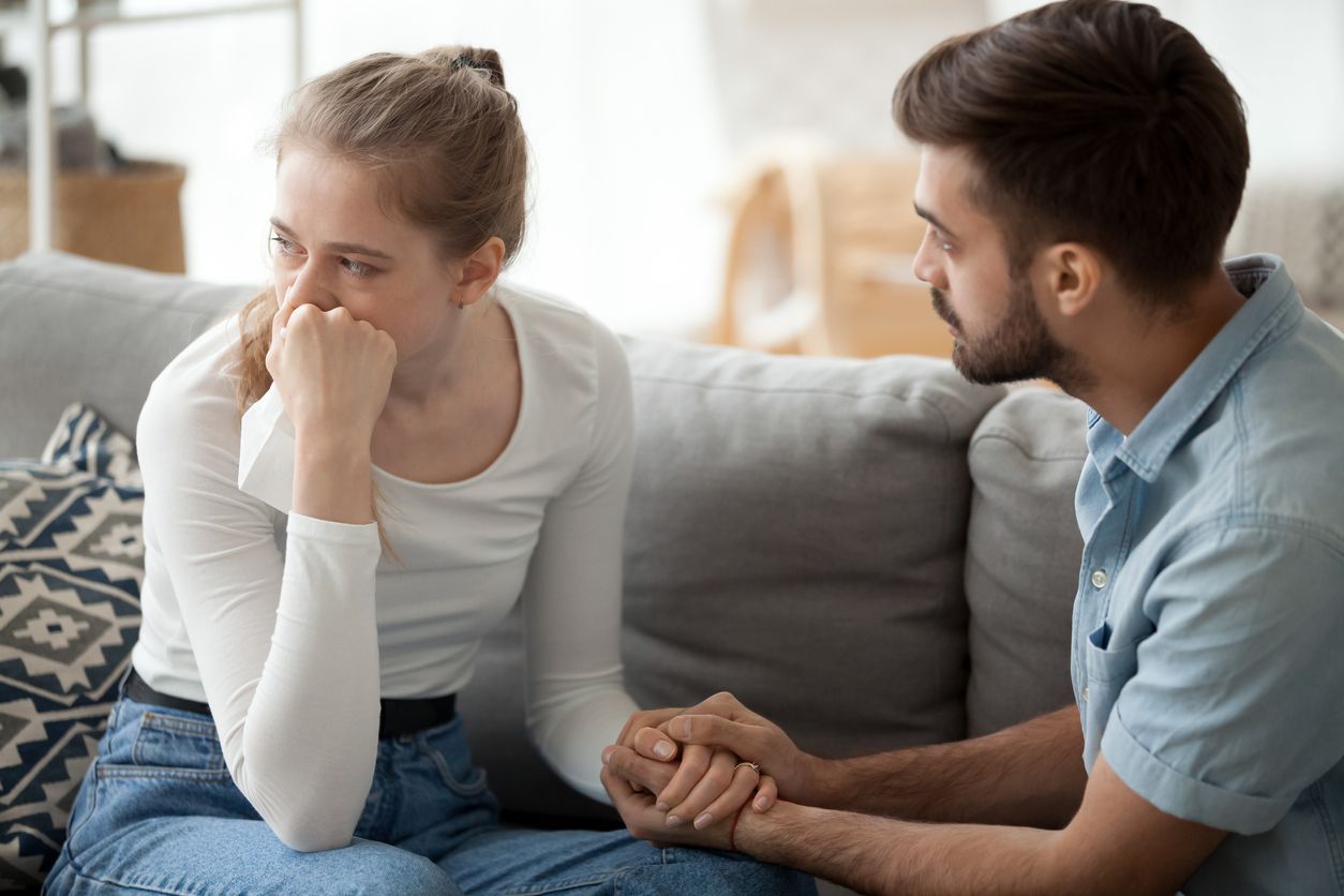Caring husband holds his wife's hand empathizing with her feelings.