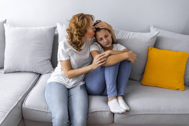 EQ mother comforting and empathizing with her preteen daughter.