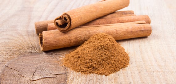 Cinnamon sticks on wooden cutting block used for autumn cooking