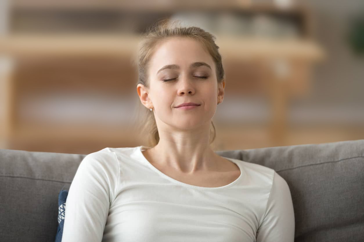 Woman breathing deeply to relax and destress