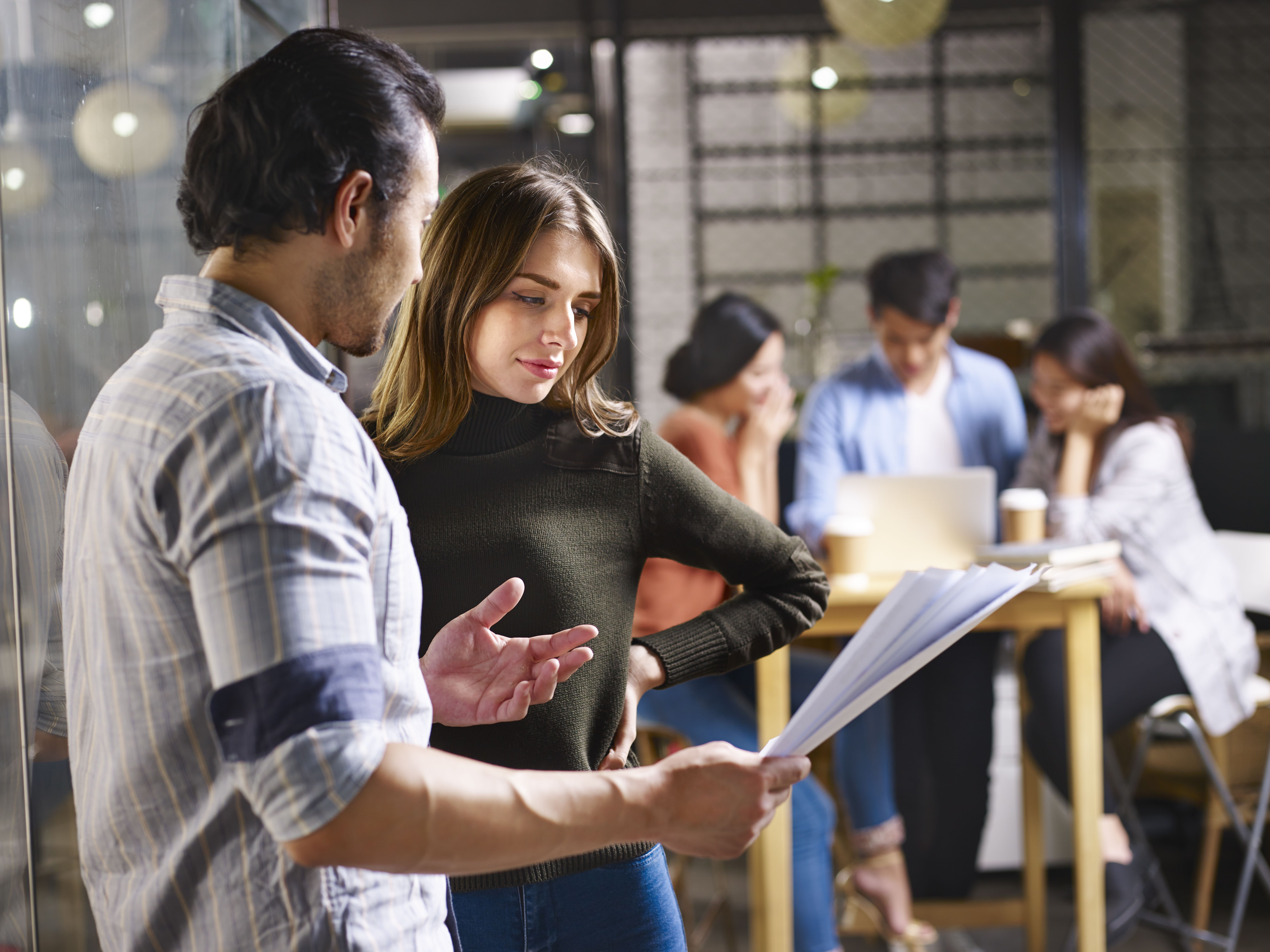 An COO speaking with an employee regarding a project.