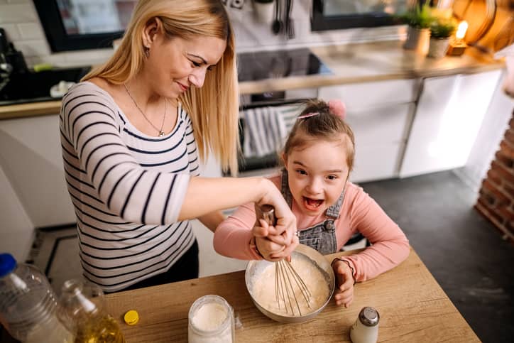 Mom baking with her Down Syndrome daughter.