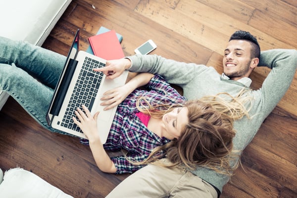 A young couple connecting while on a computer