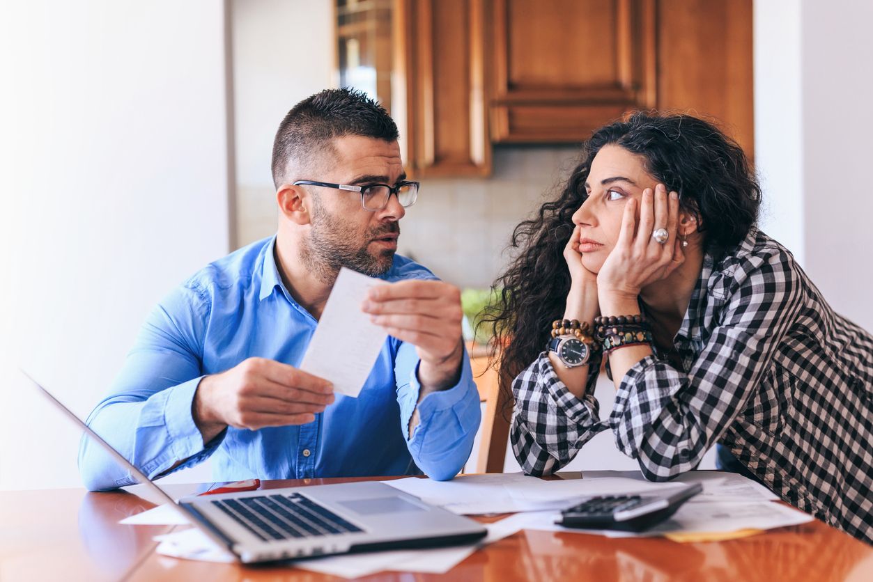 A married couple stressed and having a disagreement about the bills.