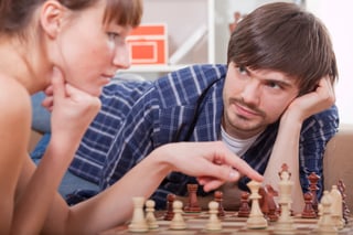 A couple playing chess A couple playing chess