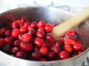 Cranberries simmering in a sauce pan for the holidays