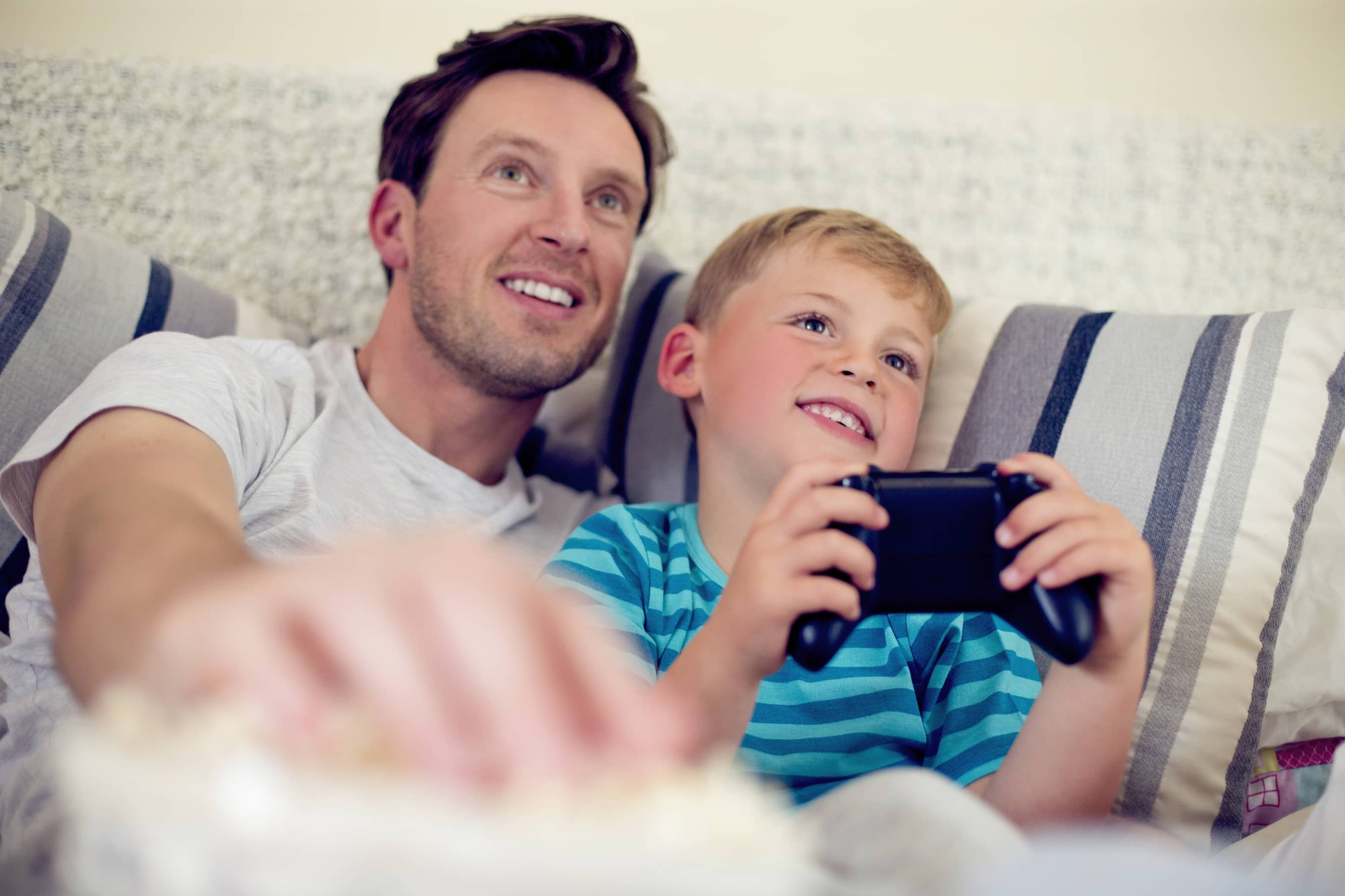 Dad playing video games with his son