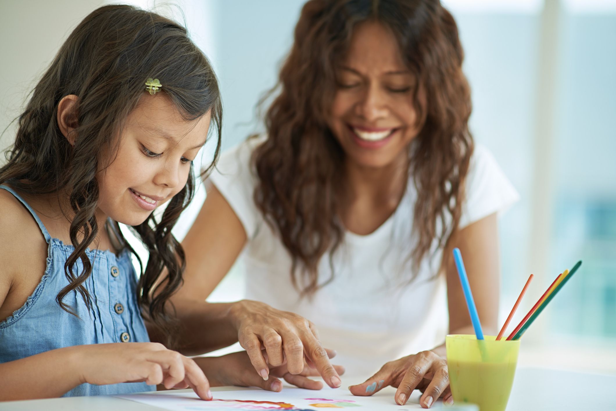 Mother and daughter doing a painting project