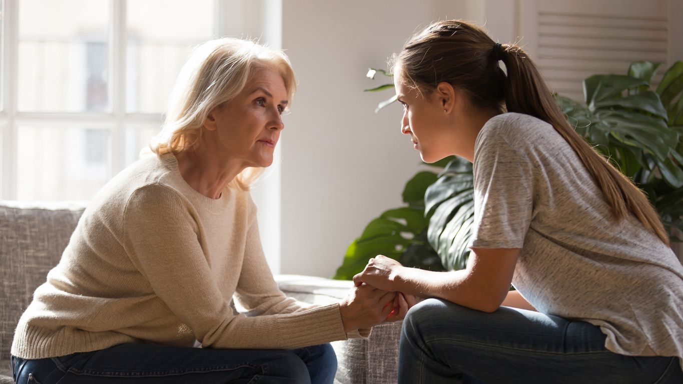 An older woman empathizing with a young woman.