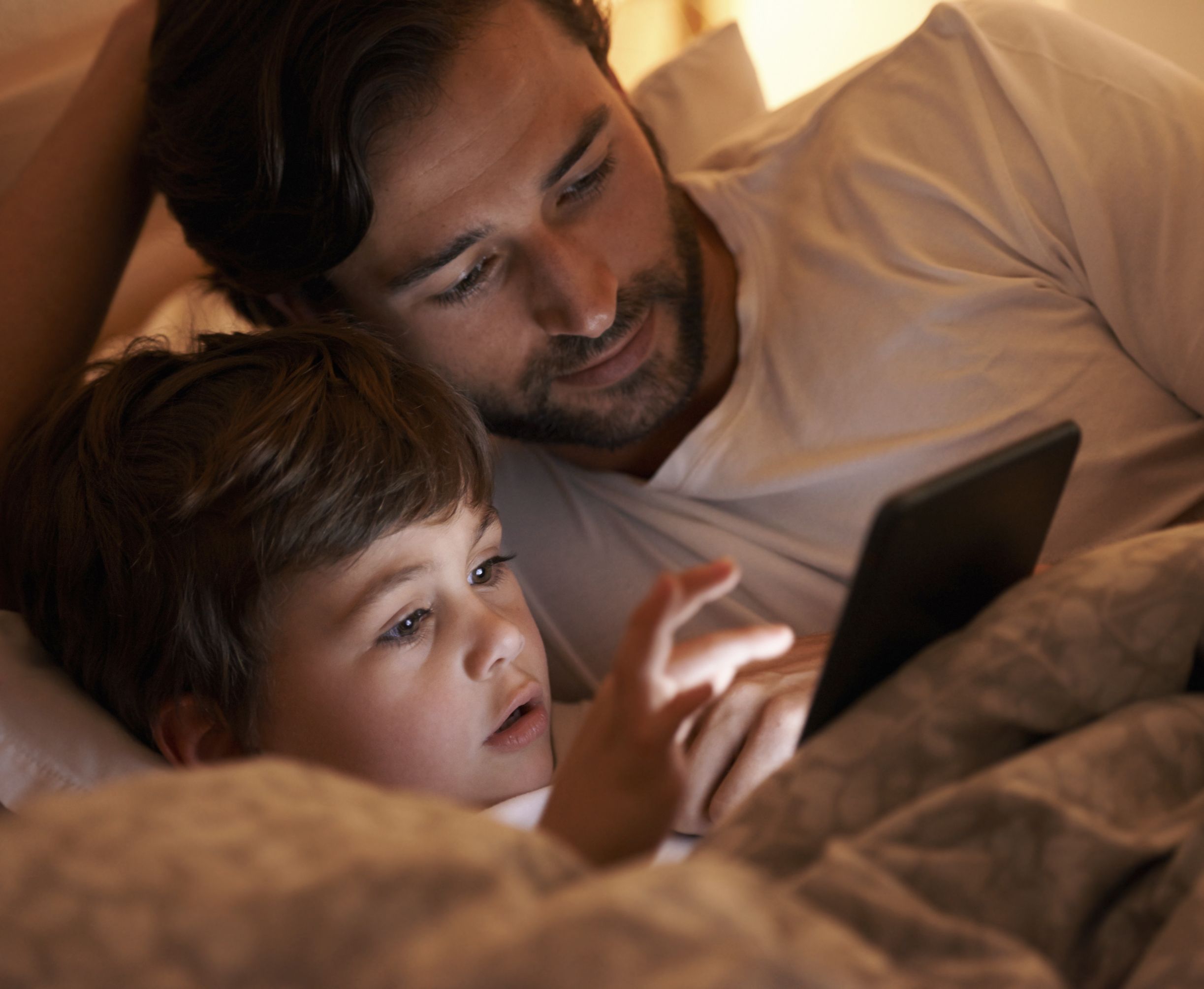 Father and son on an iPad spending time together