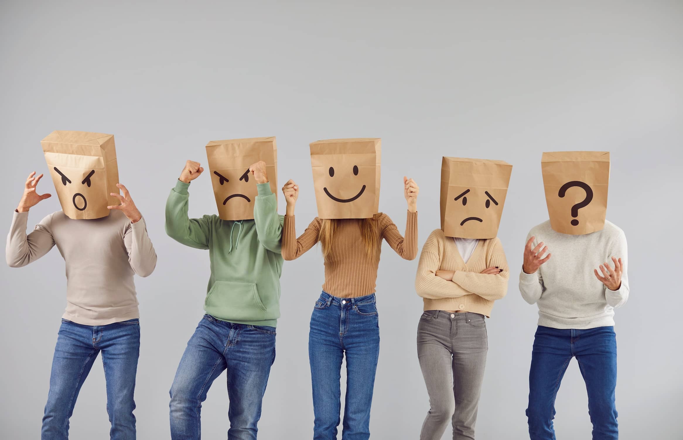 Disguised personalities wearing brown bags on their heads showing different emotions and the empathy gap.