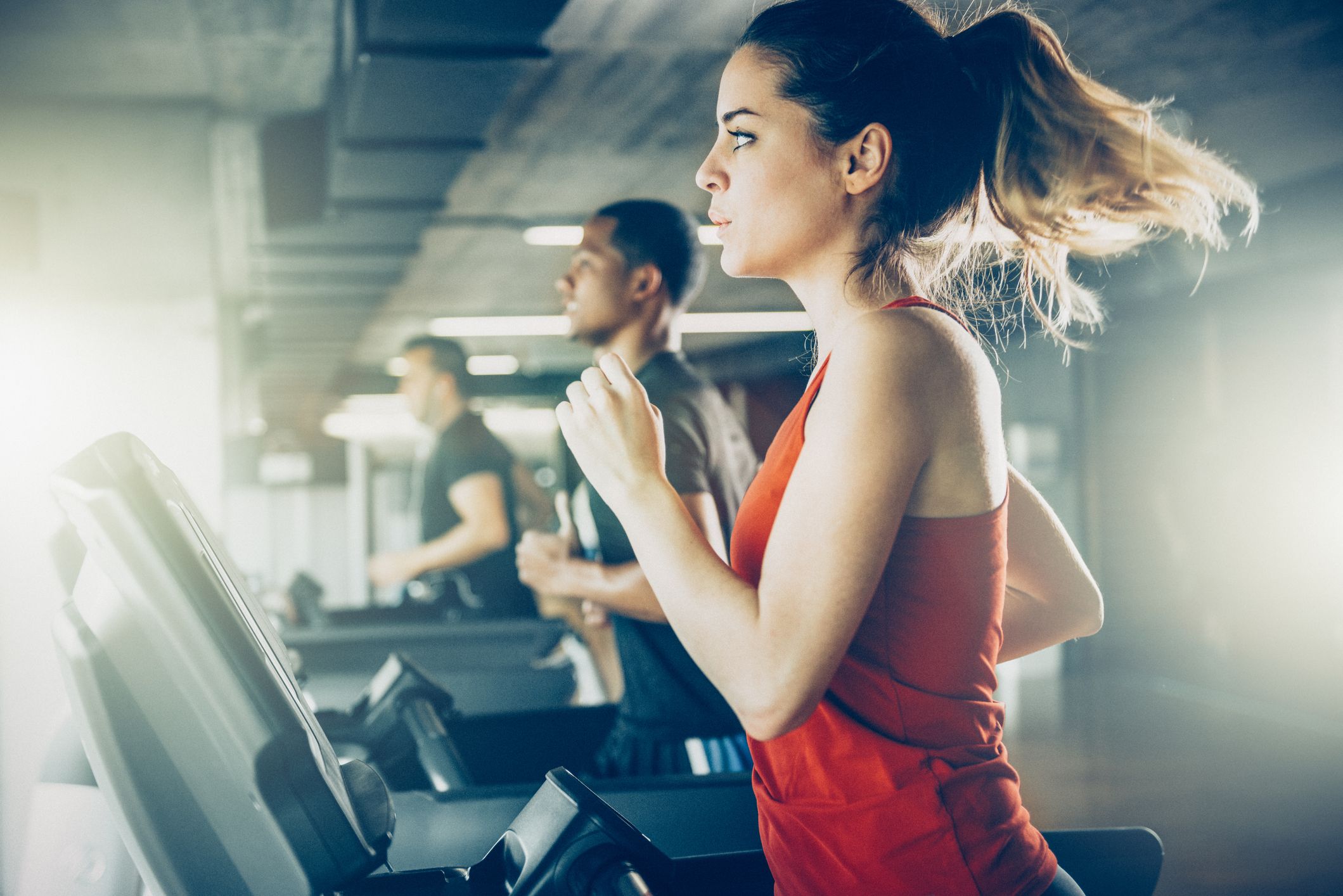 People working out and running on a treadmill at the gym with a New Year's Resolution to get fit.