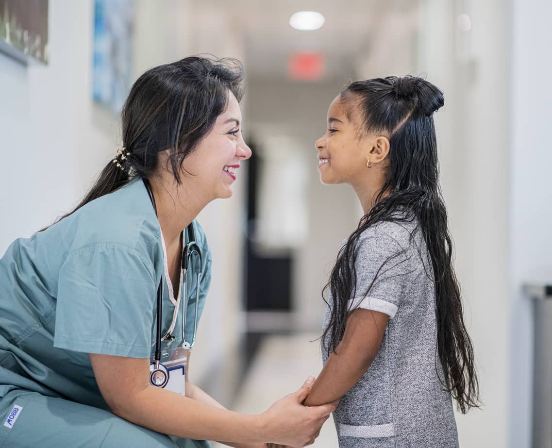 Doctor talking and empathizing with a little girl