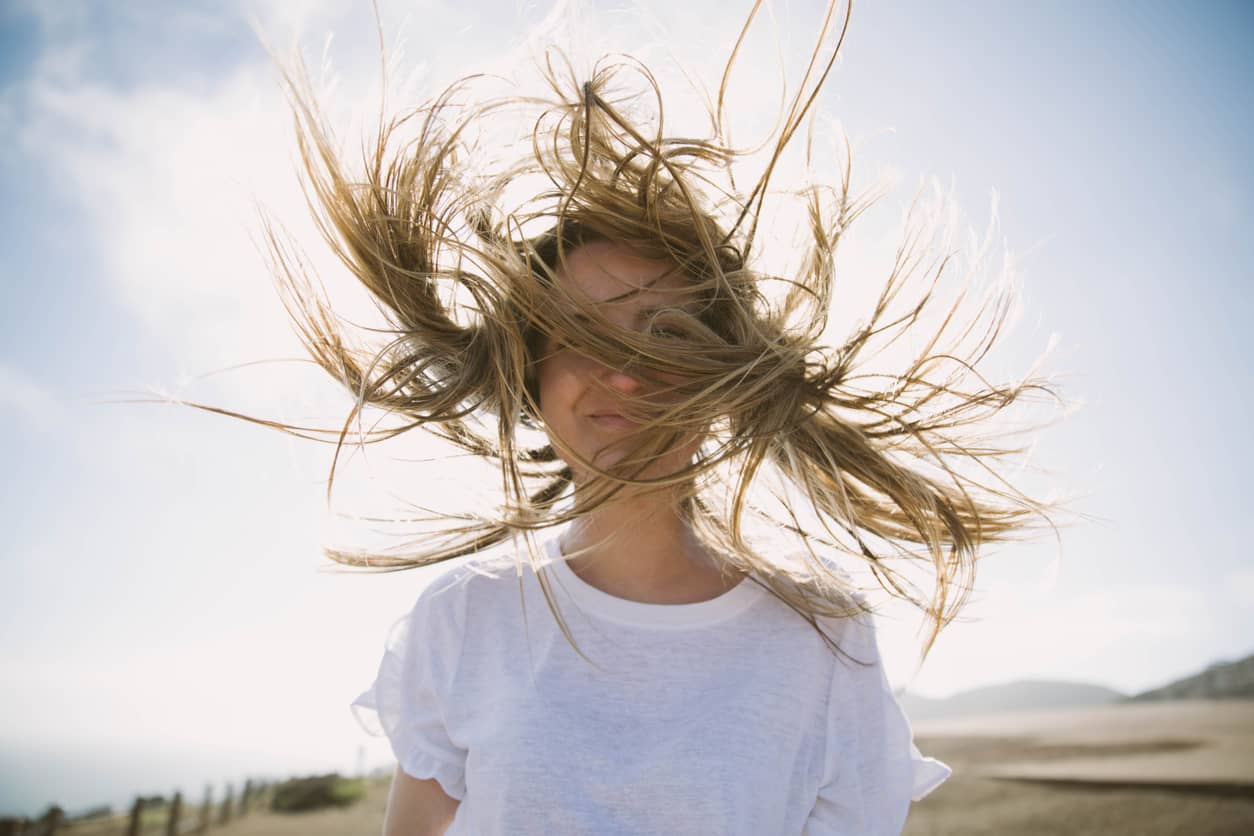 The wind blowing a woman's hair around wildly representing the wind of unregulated emotions.