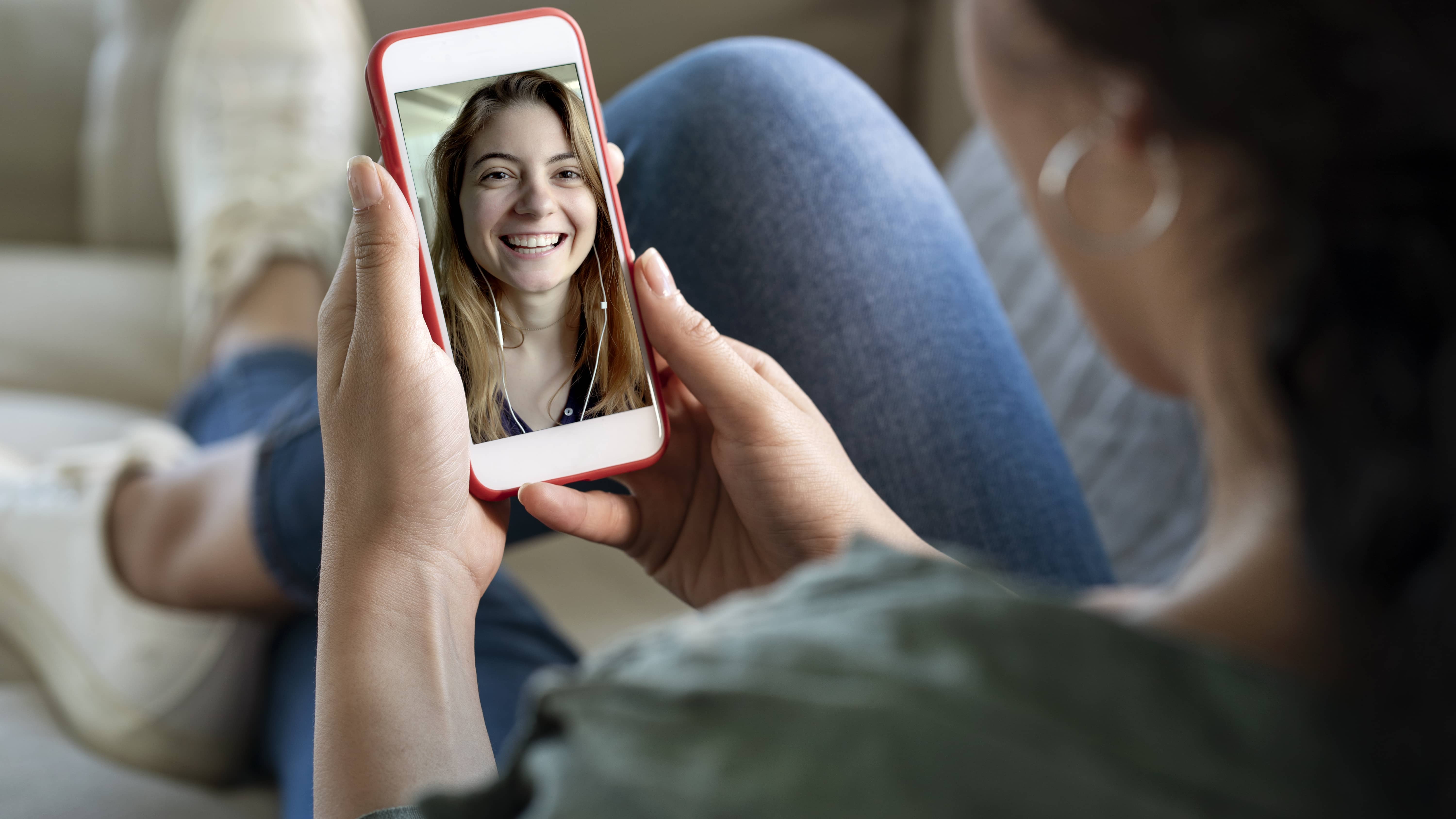 Two teenage girls facetiming.