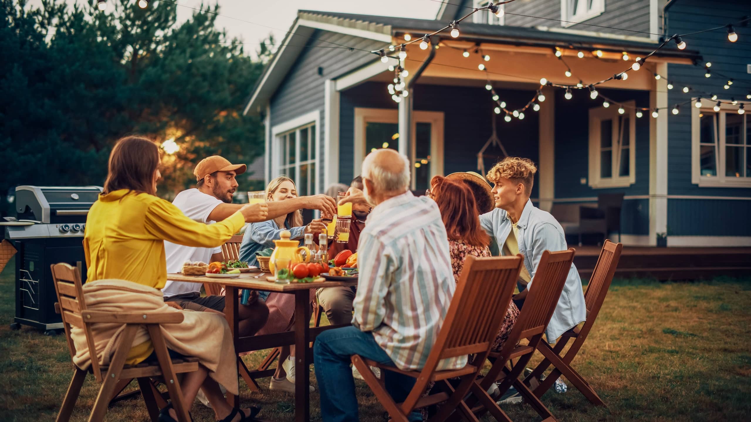 A family having picnic in backyard eating a meal from their garden.