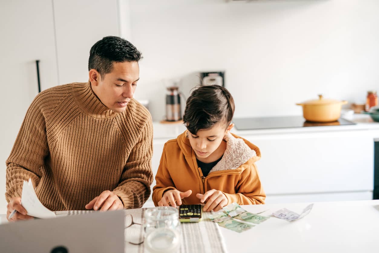 Father working with his teen son about finances.