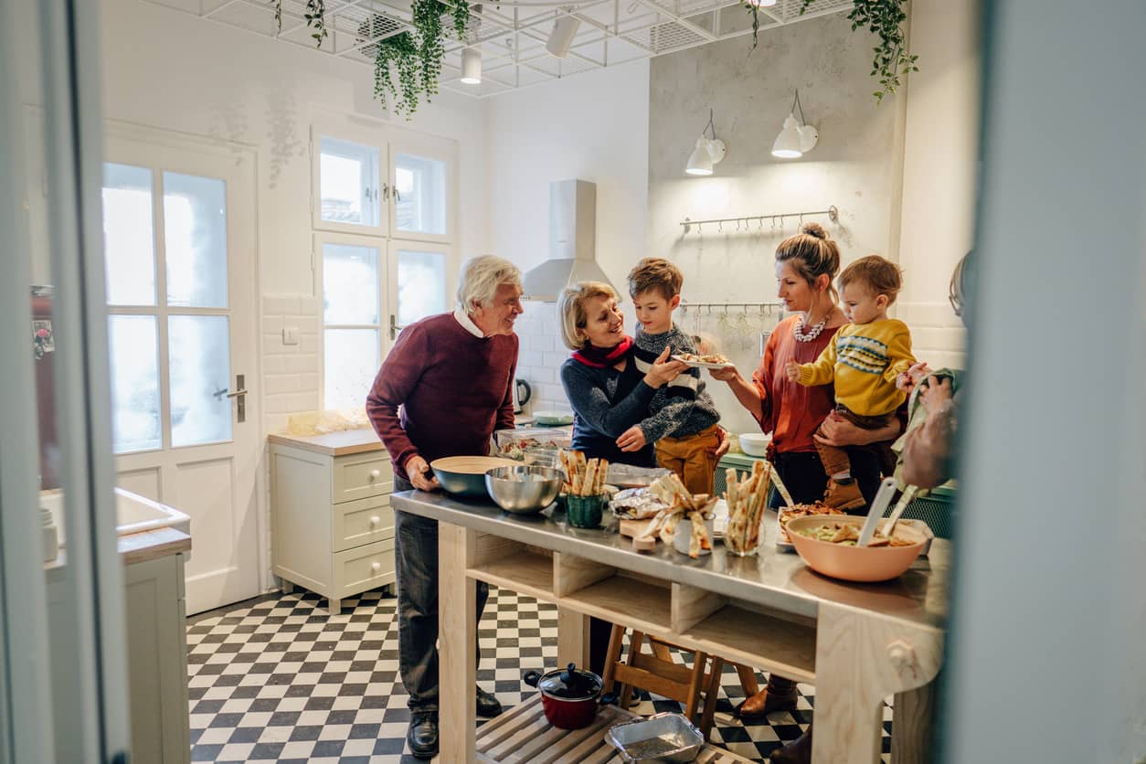 Blended family preparing a meal in the kitchen.