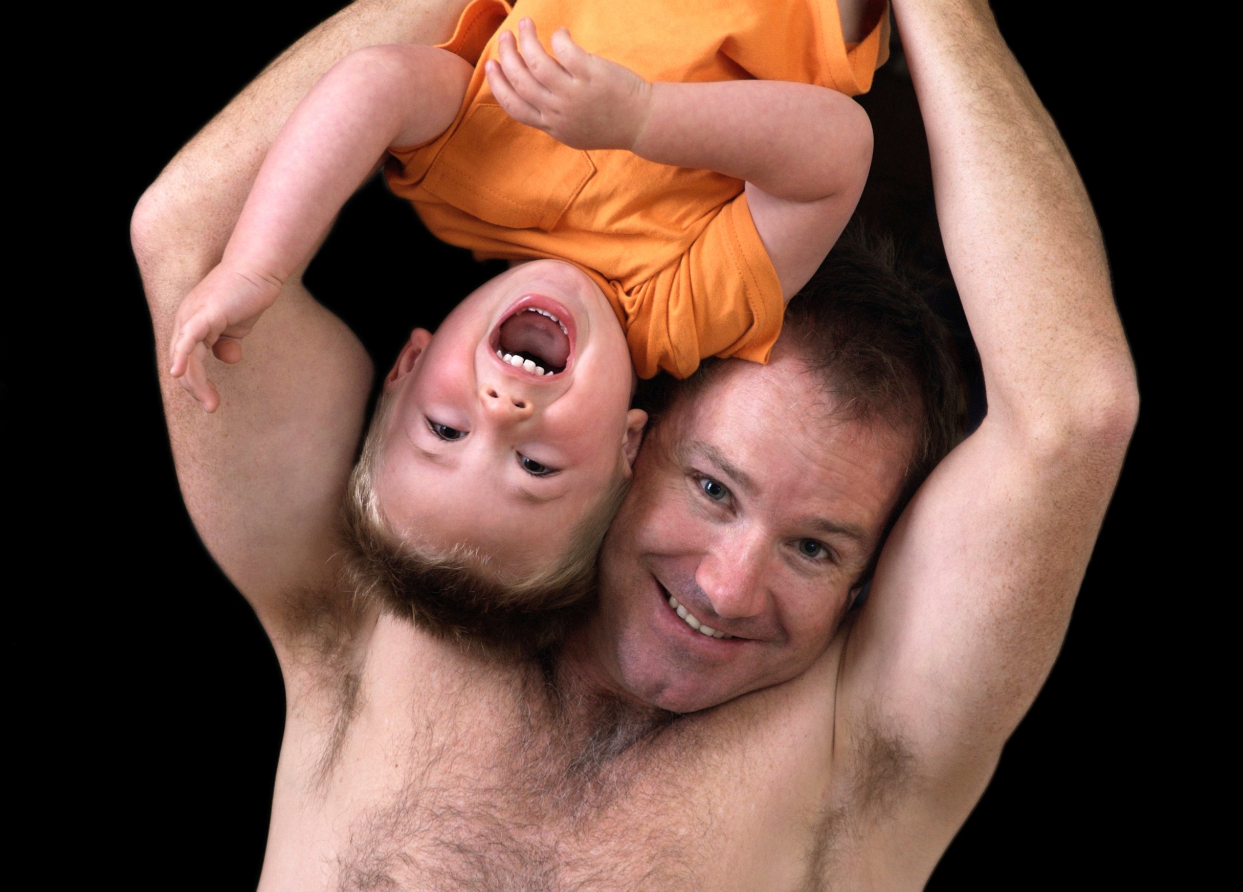 Father roughhousing with his son on Father's Day.