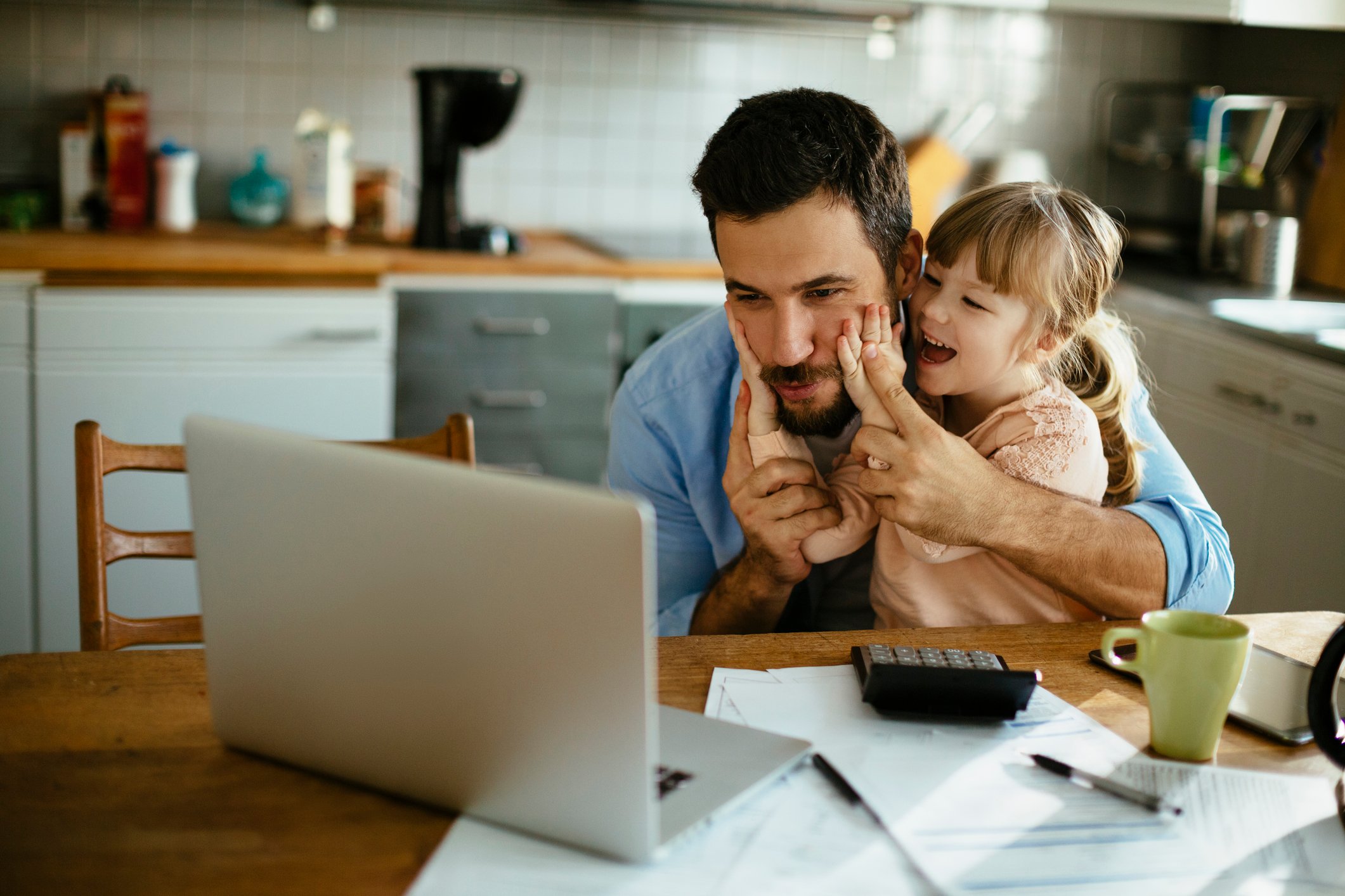 Entrepreneur working while his little girl plays