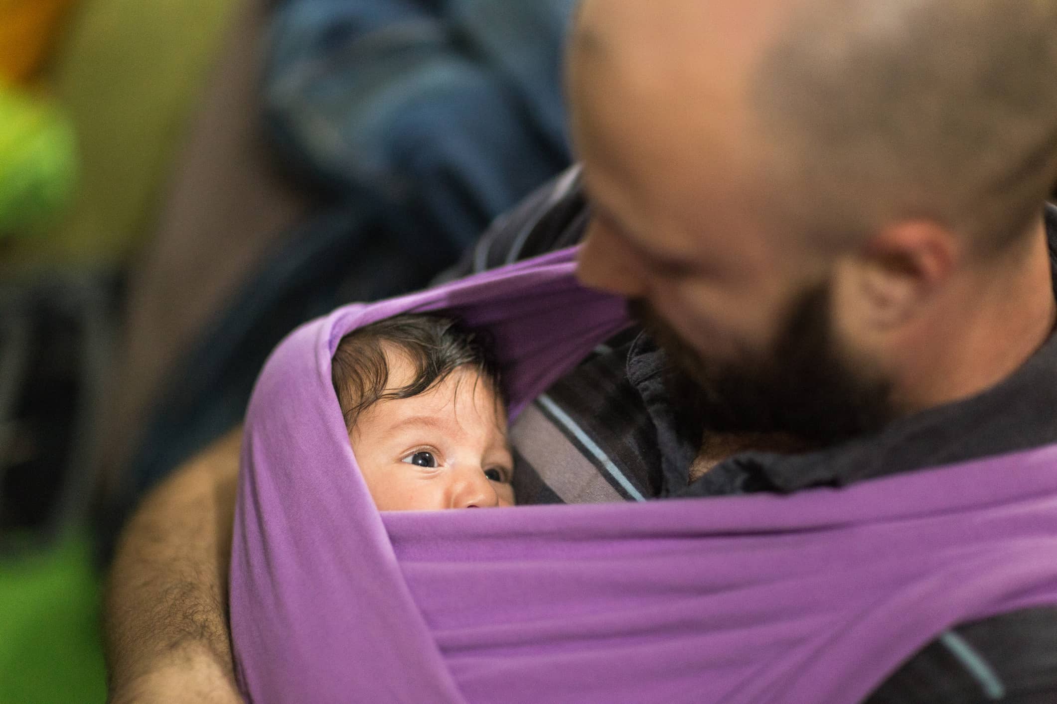 Father carrying his newborn in a wrap