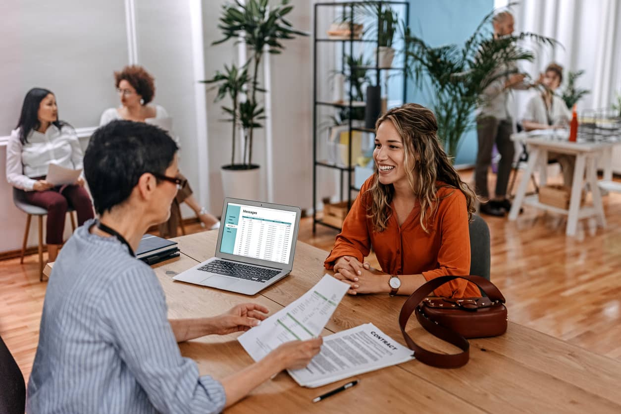 HR manager interviewing a potential employee in the office.