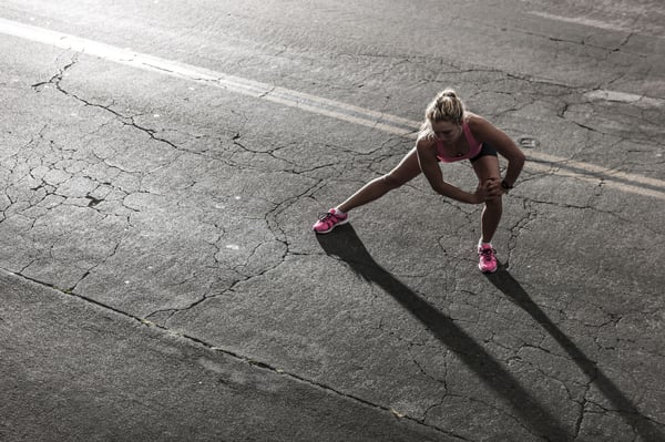 Female runner stretching before a marathon