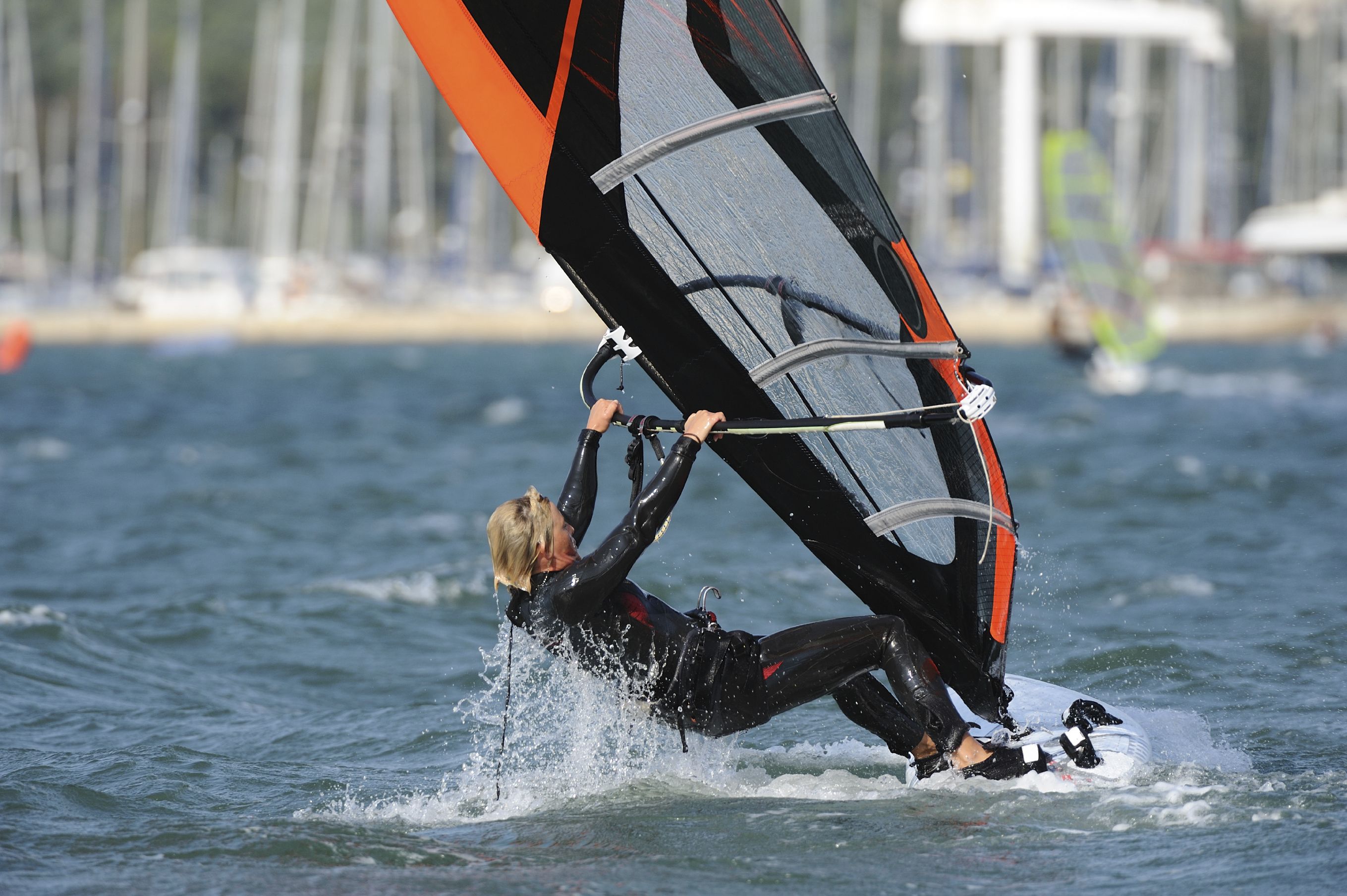 Woman windsurfing on a lake