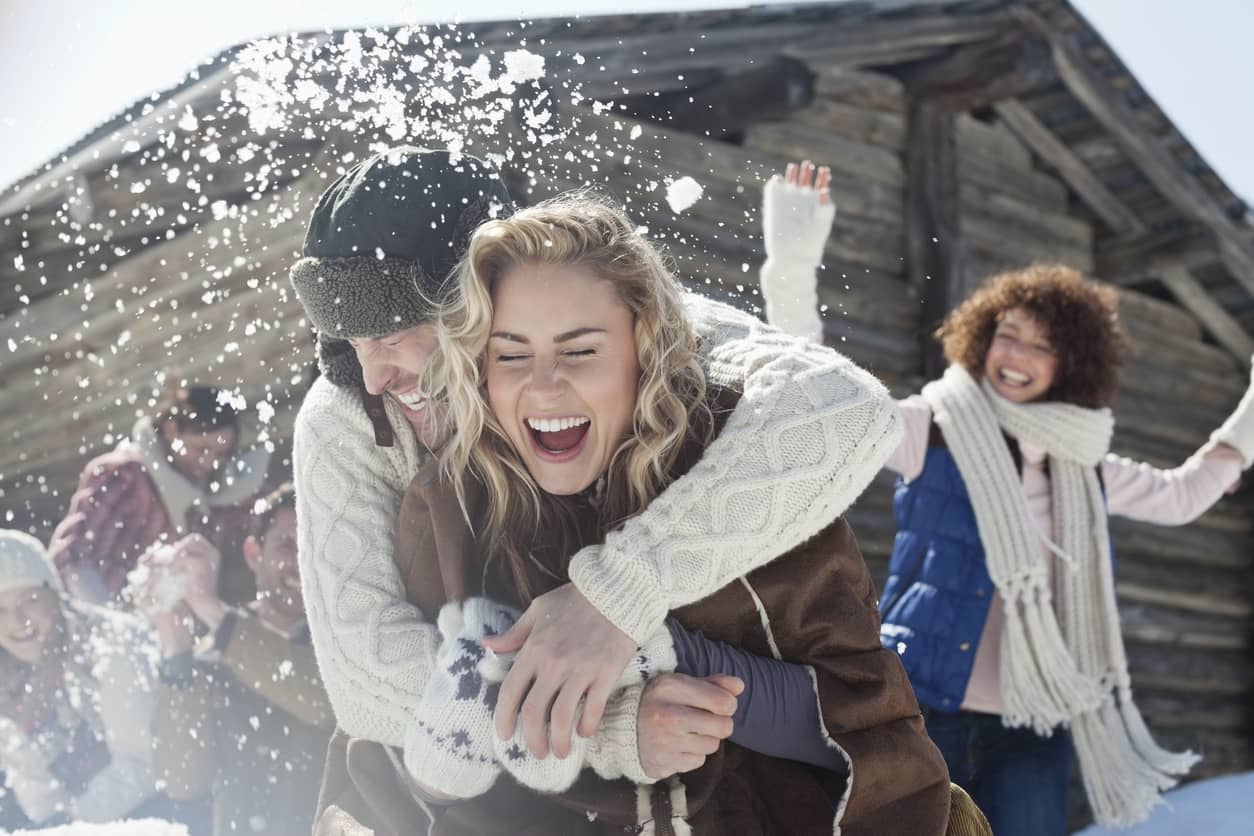 Friends enjoying a snowball fight.