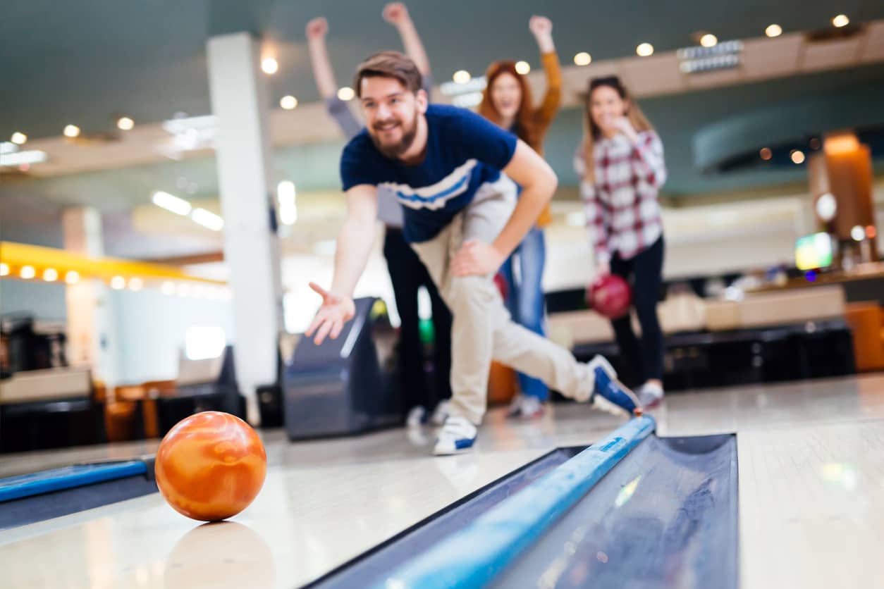 Friends bowling and having fun together